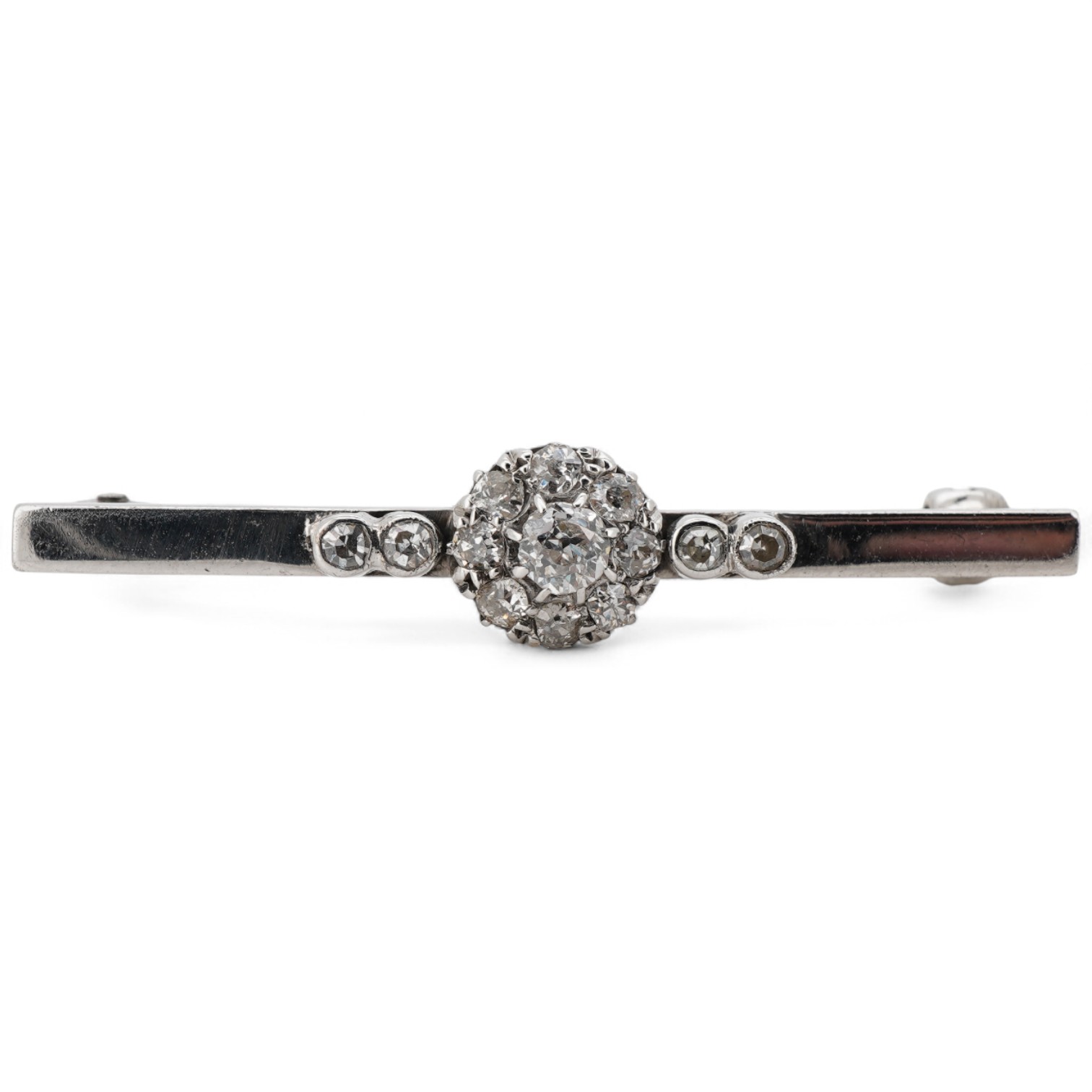 A white metal (stamped 9ct W.G.), and diamond cluster set bar brooch, 38mm.